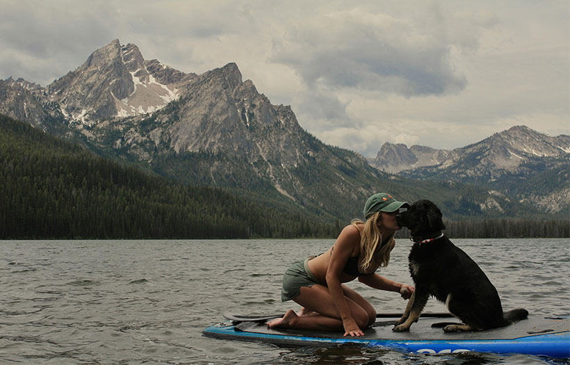 A dog and owner paddleboarding