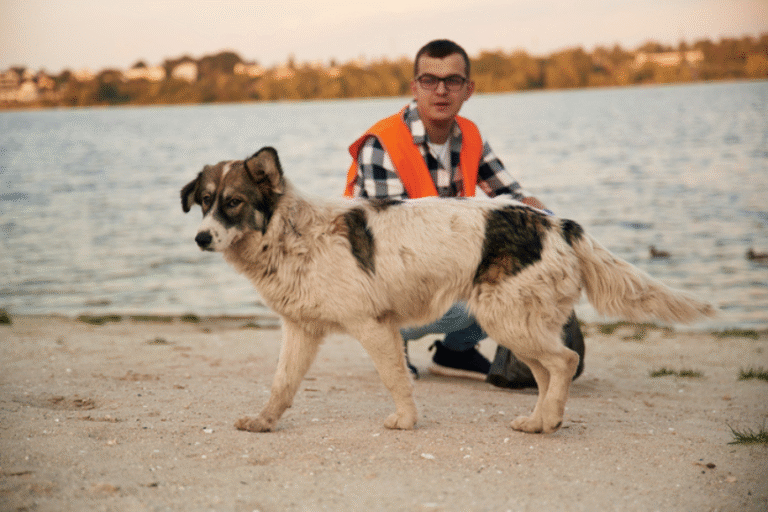 man with dog by lake
